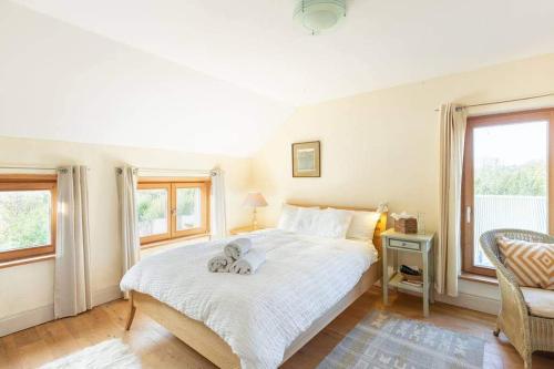 a bedroom with a bed with a cat laying on it at Kenmare Eco Lodge in Kenmare