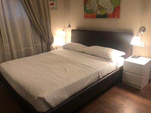 a bed with a white comforter and pillows in a bedroom at Linate Residence in Segrate