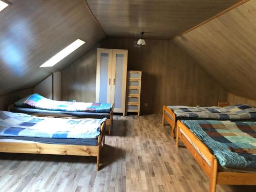 a attic room with two beds and a closet at Bieszczadzki Klin BKLIN in Cisna