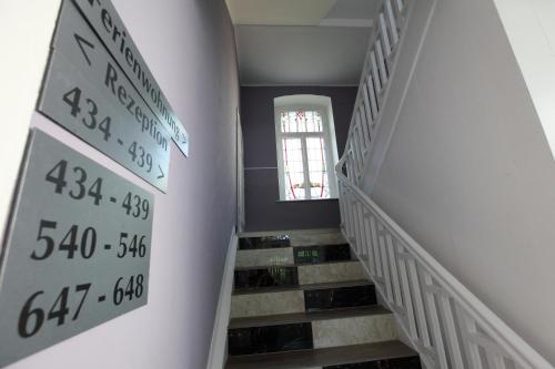 a hallway with stairs with numbers on the wall at Hotel Sofia in Bad Wildungen