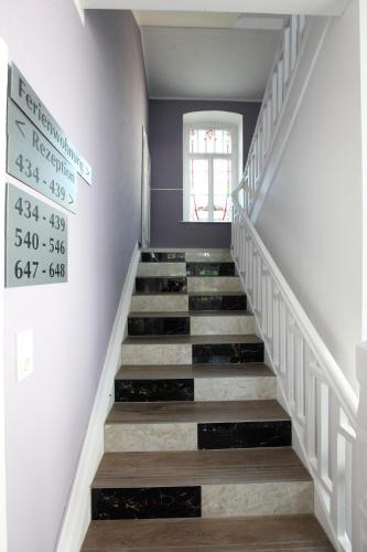 a stairway with a sign on the wall at Hotel Sofia in Bad Wildungen