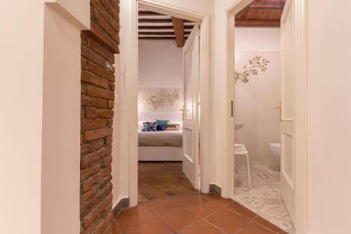 a hallway with a brick wall and a bathroom at Casa Dora in Florence