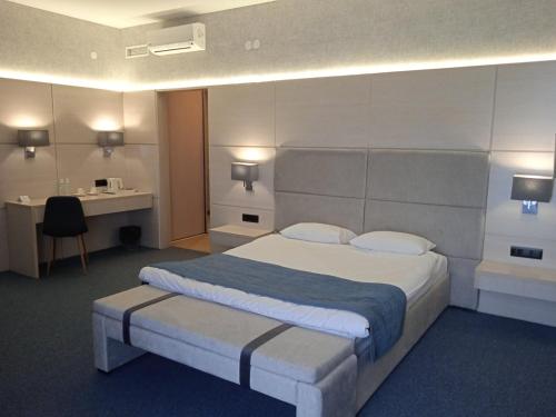 a hotel room with a bed and a desk at Hotel Zefir in Drohobytsch