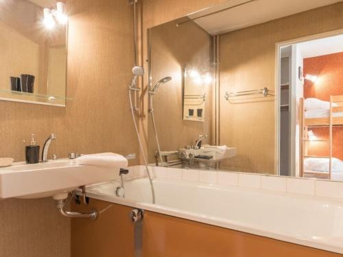 une salle de bain avec un lavabo, une baignoire et un miroir dans l'établissement Studio 4 pers. à Serre-Chevalier avec balcon, parking, animaux admis - FR-1-330E-58, à Saint-Chaffrey