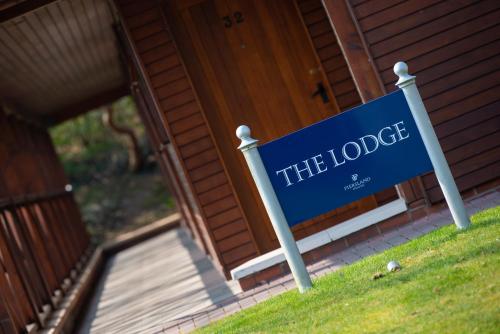 a blue sign in front of a house at Piersland House in Troon