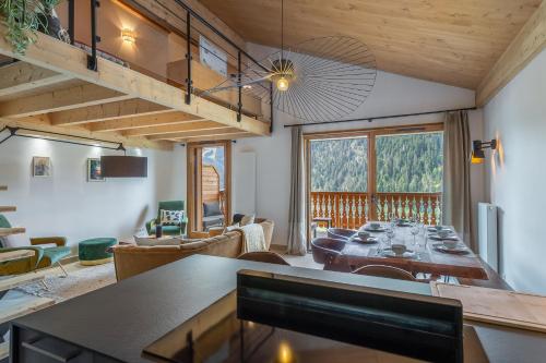 a dining room and living room with a large table at Perle de Savoie - Apt B401 - BO Immobilier - Châtel -remises sur les forfaits de skis Châtel ou Portes du soleil in Châtel