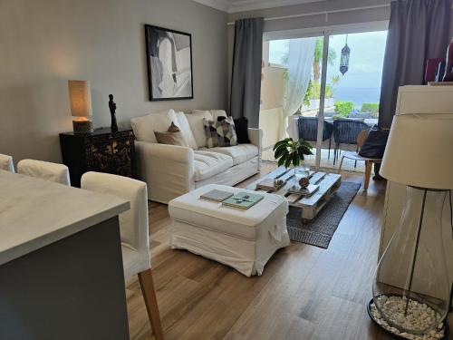 a living room with a couch and a table at Los Órganos Luxe in Puerto de la Cruz