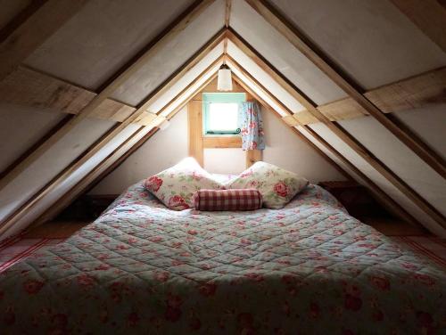 a bedroom with a bed in a attic at Forest Garden Shovelstrode in East Grinstead