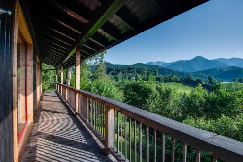 a balcony of a house with a view of the mountains at Künstlervilla mit grandiosem Panoramablick in Fischbachau