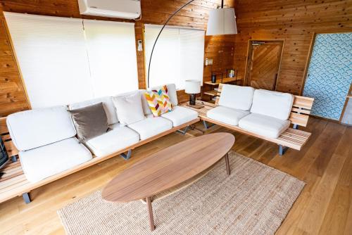 a living room with a white couch and a table at Cottage Coliberty - Vacation STAY 60526v in Anan