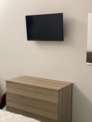 a flat screen tv hanging on a white wall at Le Quattro Perle in Terrasini