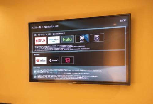 a flat screen tv hanging on a wall at Prince Smart Inn Ebisu in Tokyo