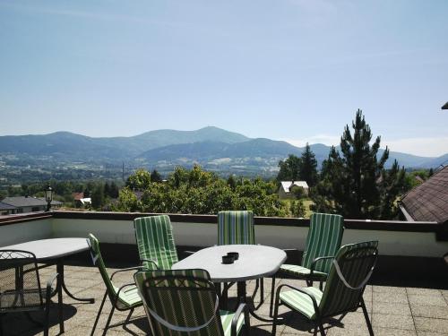 a group of tables and chairs on a roof at Penzion Na Vyhlídce in Frýdlant nad Ostravicí
