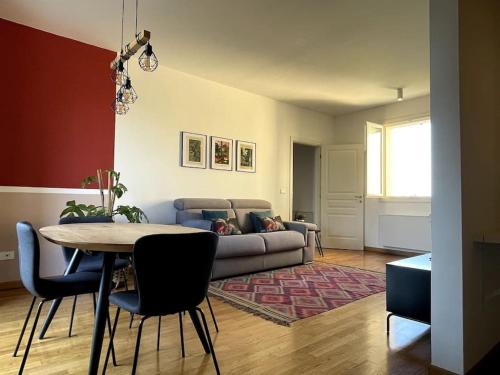 a living room with a couch and a table at Appartamento moderno in Tenuta Melloni in Anzola dell'Emilia