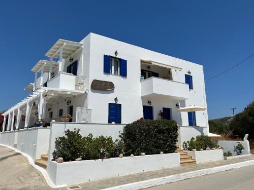 a white house with blue doors and windows at Stolidi in Adamantas