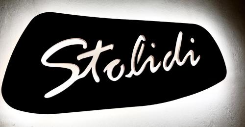 a black and white sign with the word sakura at Stolidi in Adamas