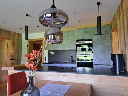 a kitchen with a table with a vase of flowers at Sonnenheim in Sonnberg