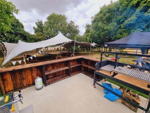 a deck of a boat with a tent and tables at Five Bells Wickham in Newbury