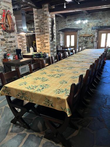 a long table in a room with chairs around it at Casa Regueirín in Lugo