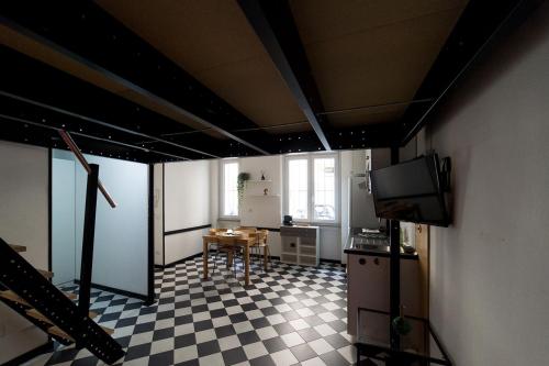 a room with a kitchen with a table and a tv at Hbhall Residenze Darsena in Milan