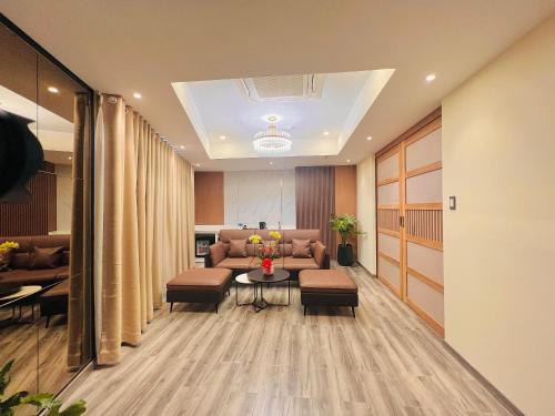 a living room with a couch and a table and chairs at Mai Vy Hotel Tay Ninh in Tây Ninh