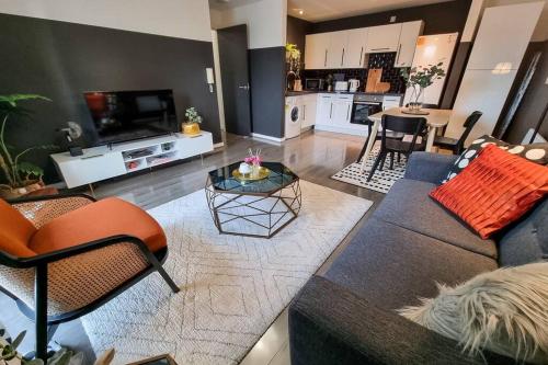 a living room with a couch and a table at Couples Retreat / Workers Paradise + Free Parking in Manchester