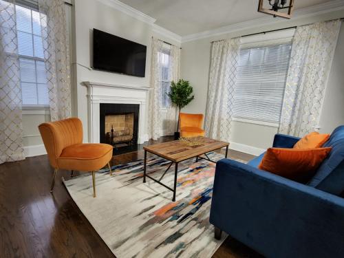 a living room with a blue couch and a fireplace at Spacious Centrally Located 3 Bed 2 Bath - Sleeps 8 in Montgomery