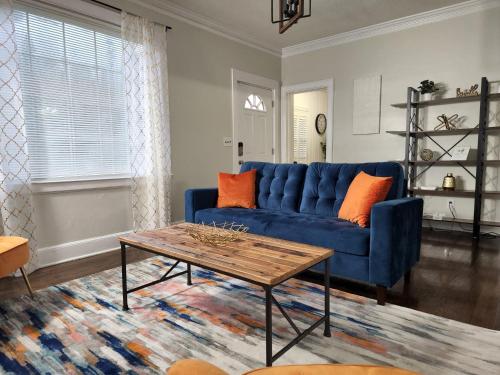 a living room with a blue couch and a table at Spacious Centrally Located 3 Bed 2 Bath - Sleeps 8 in Montgomery
