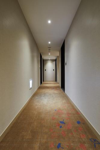 an empty hallway with a carpet on the floor at K Hotels Taipei Linsen in Taipei