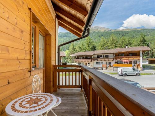 a balcony with a table and a chair and a building at Apartment Lore - SOE 301 by Interhome in Sölden