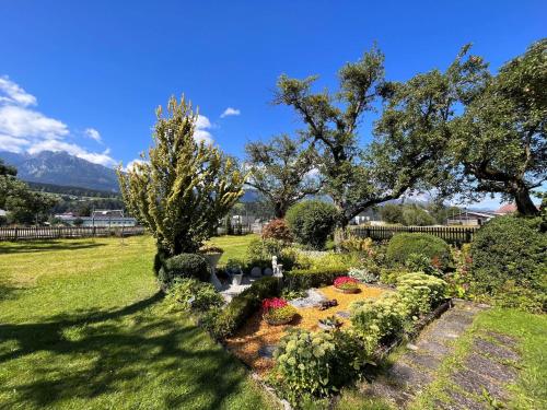 a garden with flowers and trees in a yard at Apartment Moser-1 by Interhome in Stein an der Enns