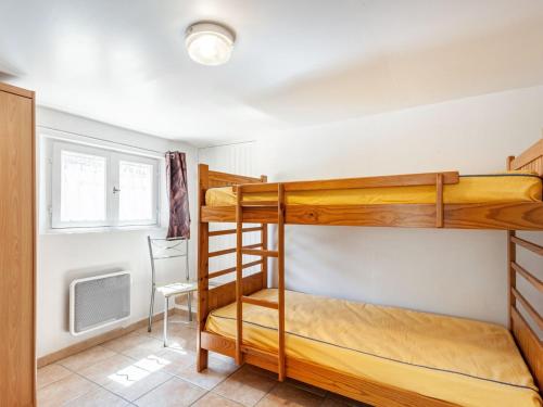 a bedroom with two bunk beds and a tv at Apartment Mireio by Interhome in Lambesc