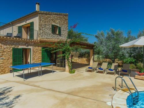 a patio with a table and chairs and a house at Holiday Home Can Marines des cami des carro by Interhome in S'Horta