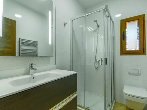 a bathroom with a sink and a glass shower at Holiday Home Can Marines des cami des carro by Interhome in S'Horta