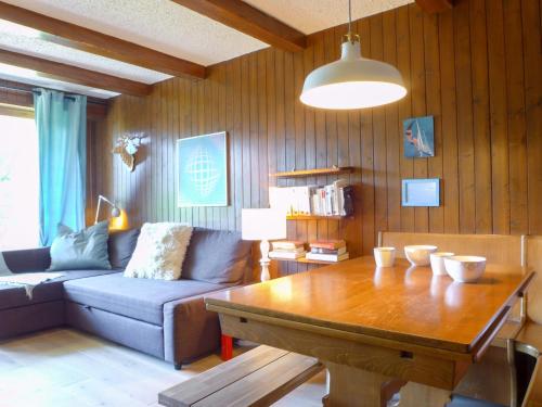 a living room with a couch and a table at Apartment Entremont 60 by Interhome in Verbier