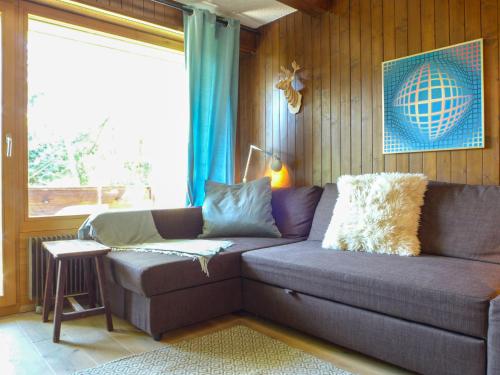 a living room with a couch and a window at Apartment Entremont 60 by Interhome in Verbier