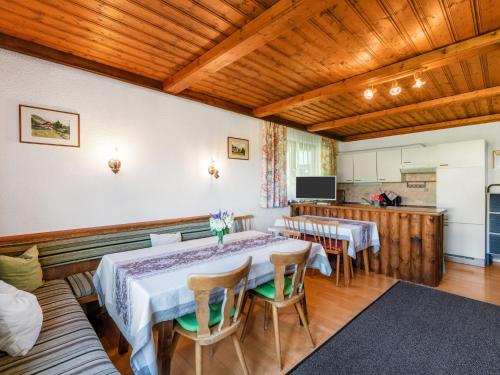 a dining room with two tables and a kitchen at Apartment Ratgebgut by Interhome in Zell am See