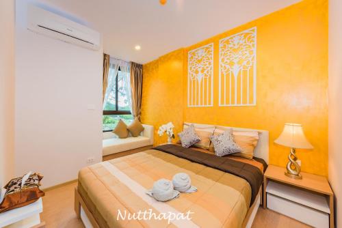 a bedroom with a bed with towels on it at Elegant room near beaches, shopping, restaurant​s in Phuket Town