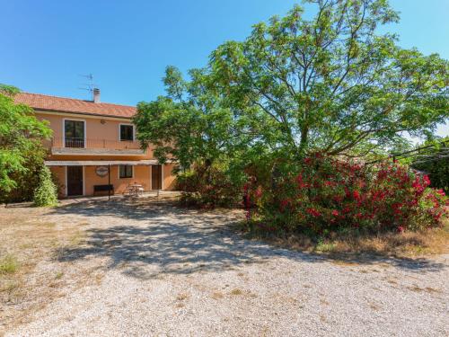 a house with a large tree in front of it at Holiday Home Fonte del Ceppo 2-2 by Interhome in Montone