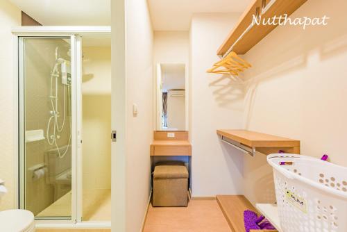 a small bathroom with a shower and a toilet at Elegant room near beaches, shopping, restaurant​s in Phuket Town