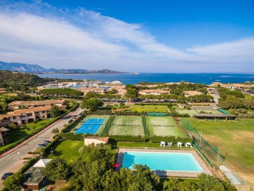 an aerial view of a resort with two tennis courts at Holiday Home House Boat Large by Interhome in San Teodoro