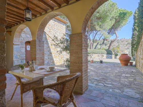 an outdoor patio with a table and chairs at Apartment Cellole - La Stalla by Interhome in Castellina in Chianti