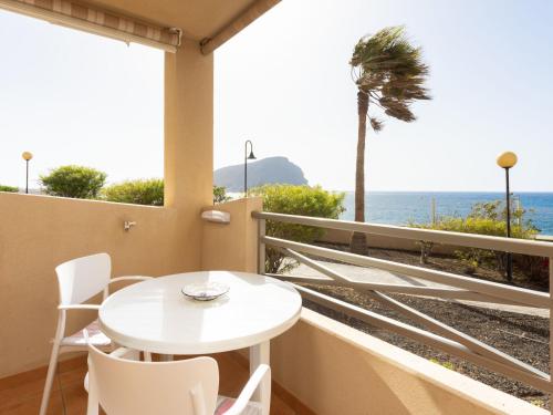 a balcony with a table and chairs and a view of the ocean at Apartment La Tejita by Interhome in La Tejita