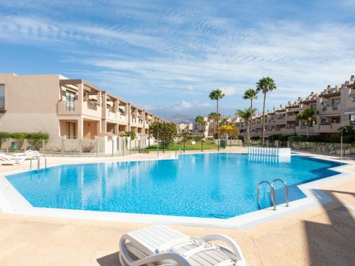 Una gran piscina en un complejo con palmeras. en Apartment La Tejita by Interhome, en La Tejita
