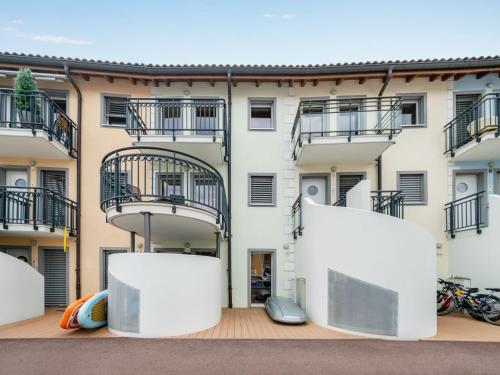 an apartment building with balconies and a patio at Apartment Apt C4-R - Résidence Bougainville by Interhome in Bouveret