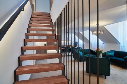 a spiral staircase in a house with blue furniture at Urpí­n City Residence in Banská Bystrica