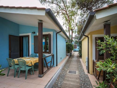 a house with a table and chairs on a patio at Holiday Home Miramare-3 by Interhome in Antignano