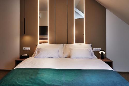 a bedroom with a large bed with white pillows at Urpí­n City Residence in Banská Bystrica