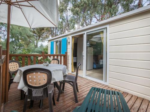 a patio with a table and chairs and an umbrella at Holiday Home Miramare-1 by Interhome in Antignano