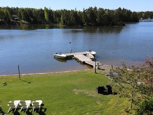 a boat sitting on a dock on a lake at Holiday Home Lövkulla by Interhome in Löparö